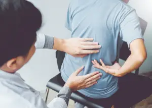 a Doctor examining someone with sciatica