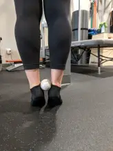 Heel raise with ball for tibialis posterior strengthening