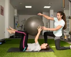 A Physical Therapist helping someone with core work