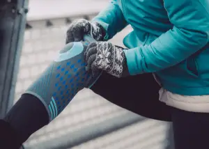 A runner wearing a knee compression sleeve