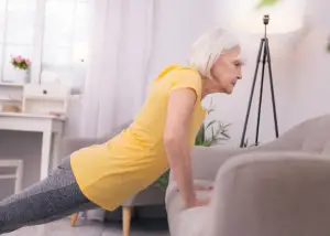 elderly woman performing modified push ups